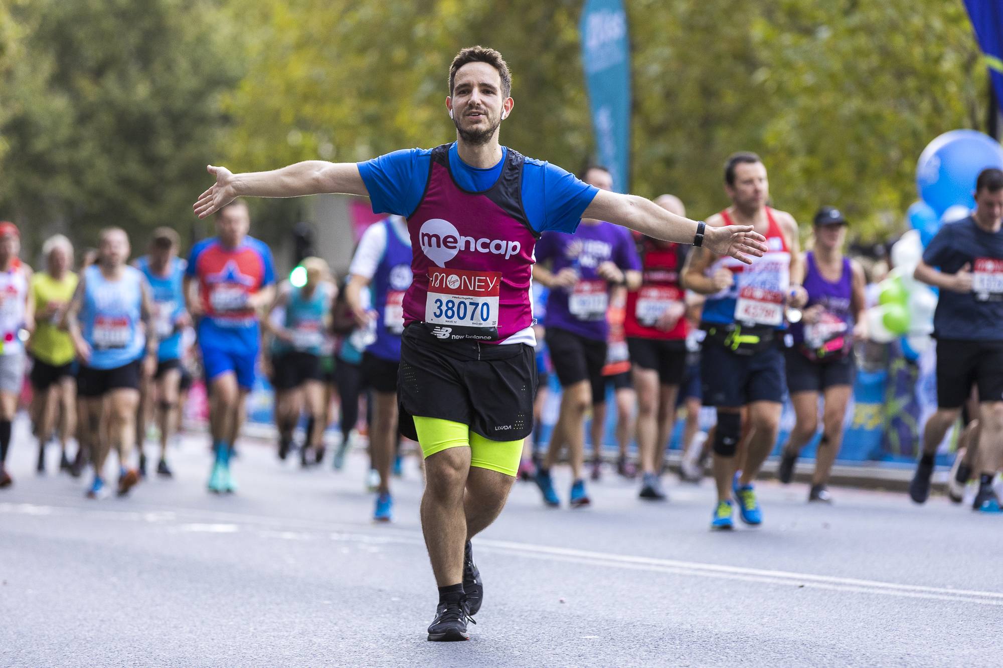 Mencap runner with his arms out